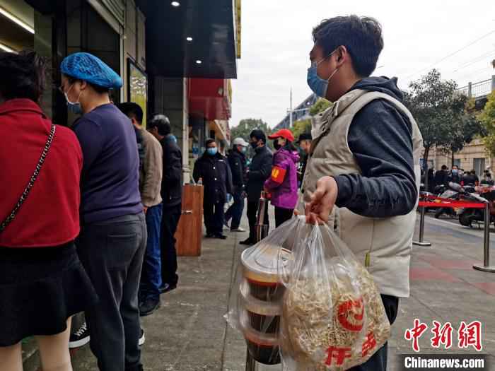 长时间没有品尝到牛肉面,一居民打包多份回家 胡传林 摄  襄阳战“疫”记:一碗牛肉面再现古城“烟火气”