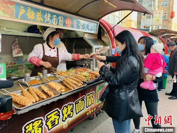 24日,潞州区延南街道淮海小吃街等小吃聚集地已恢复了往日的热闹。 任静  摄  “烟火气”渐浓 山西潞州各行各业复工忙